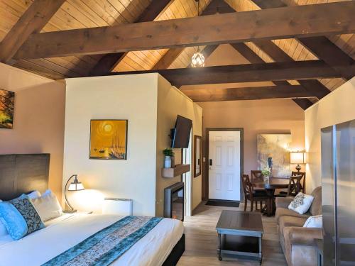 a bedroom with a large bed and a living room at Wanderlust Inn in Ocean Shores