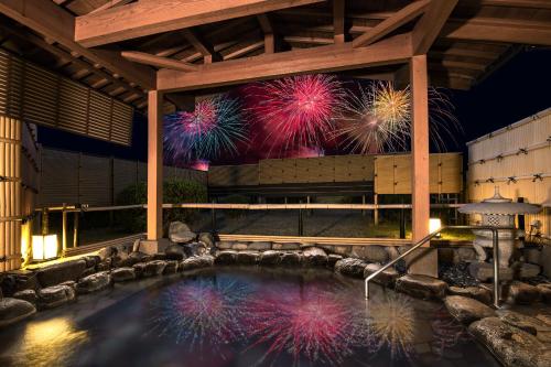 a pool of water with fireworks in the background at Asagiriso in Toyooka