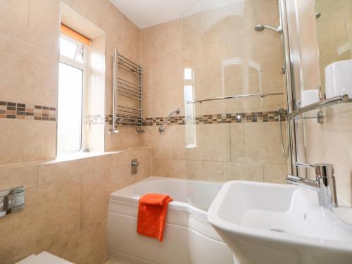 a bathroom with a tub and a sink and a shower at Loose Hill Lea in Bamford