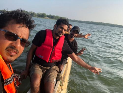 a group of men on a boat in the water at Lapwing Lake Villa in Tissamaharama