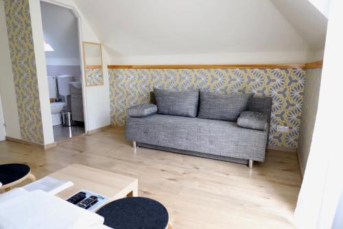 a living room with a couch and a table at Jade Panzio in Balatonföldvár