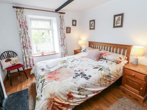 a bedroom with a large bed and a window at Arklehurst in Low Eskcleth