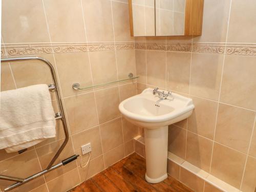 a bathroom with a sink and a shower at Arklehurst in Low Eskcleth