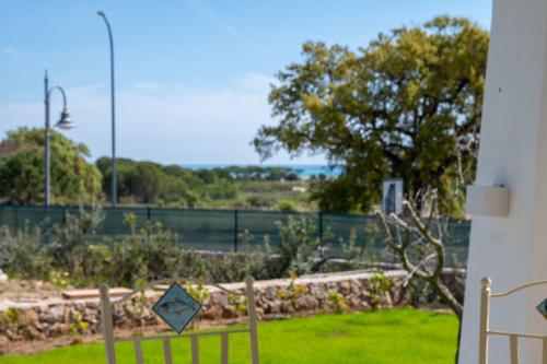 a view of a yard with a fence and grass at ENAJA - Luxury Retreat in Budoni