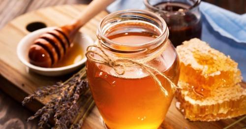 a table with a jar of honey and some bread at Honey Aquapark View in Płock
