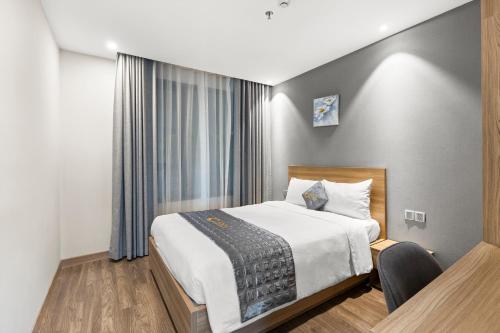 Katil atau katil-katil dalam bilik di Moon Hotel and Apartment Da Nang