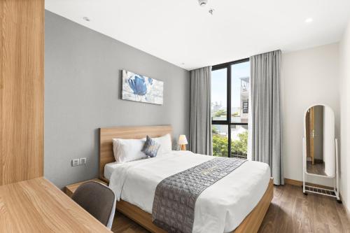 Ένα ή περισσότερα κρεβάτια σε δωμάτιο στο Moon Hotel and Apartment Da Nang