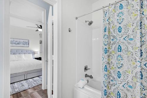 a bathroom with a tub and a shower curtain at Destiny Beach Villas #15A in Destin