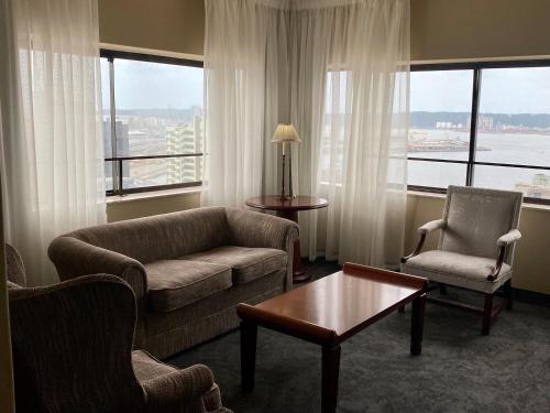 a living room with a couch and two chairs and a table at The Royal Hotel by Coastlands Hotels & Resorts in Durban
