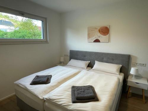 a bedroom with a large bed with two pillows on it at Ferienbungalow Kampenheissji in Wiltingen