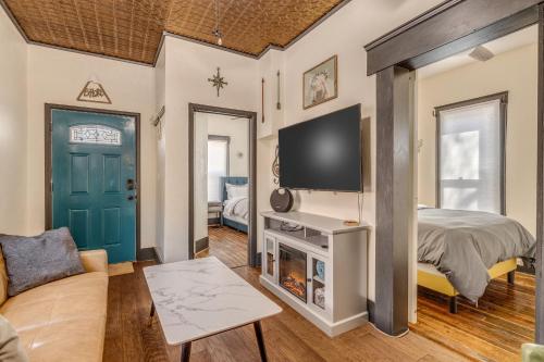 a living room with a bed and a tv at Downtown Colorado Springs House in Colorado Springs