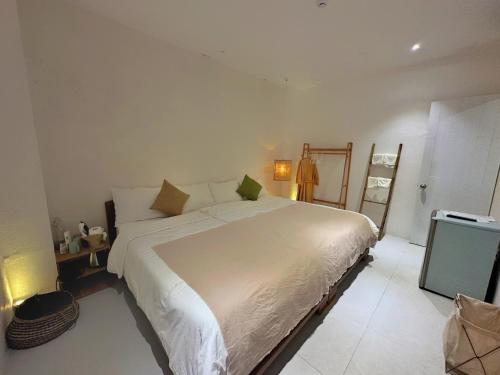 a bedroom with a large white bed and a television at VV House Quy Nhon Homestay in Quy Nhon