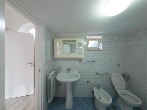 a bathroom with a sink and a toilet and a mirror at Sorrento Realty Holidays - The smile of the sun in Sorrento