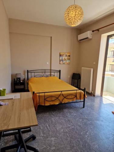 a bedroom with a bed in a room with a table at ComeHome in Heraklio Town