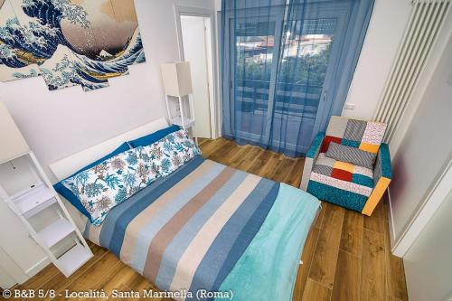 a small bedroom with a bed and a chair at CINQUE OTTAVI B&B in Santa Marinella