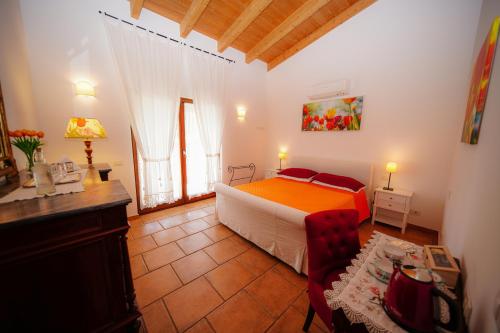 a bedroom with a bed and a couch in a room at Fonte Murata B&B in Portoferraio
