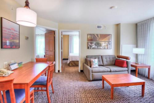 a living room with a table and a couch at TownePlace Suites Raleigh Cary/Weston Parkway in Cary