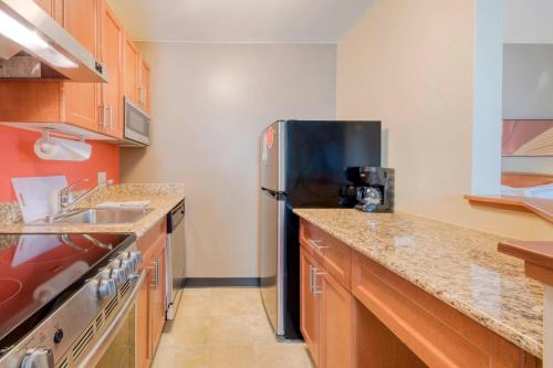 a kitchen with a stainless steel refrigerator and a sink at TownePlace Suites Raleigh Cary/Weston Parkway in Cary