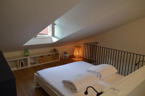 a bedroom with a white bed in a attic at Casa Cristina in Cannobio