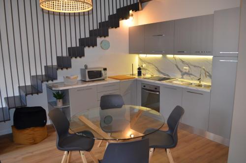 a kitchen with a glass table and chairs at Casa Cristina in Cannobio