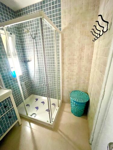 a shower with a glass door in a bathroom at CasAzul in Olhão