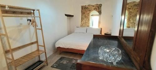 - une petite chambre avec un lit et un miroir dans l'établissement Cantina nel Castello, à Montegiovi