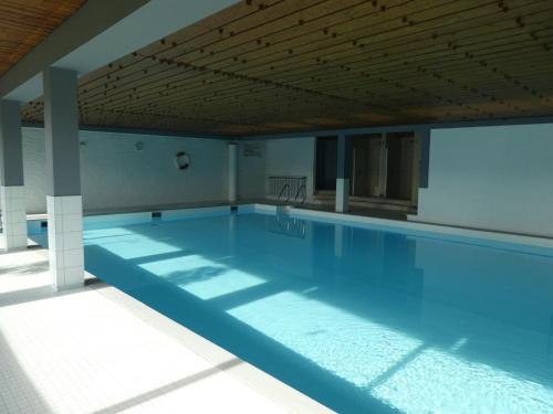 a large swimming pool in a building at Ferienwohnung Moritz in Oy-Mittelberg