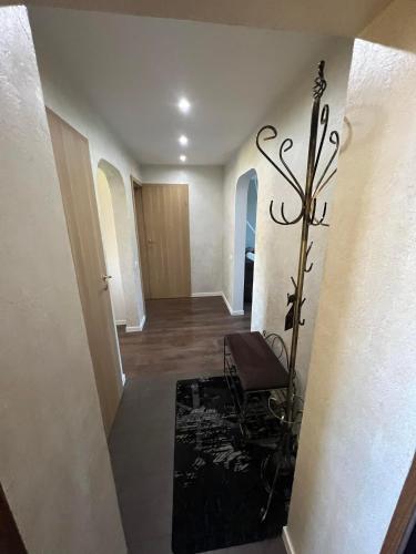 a hallway with a stairway with a bench in it at LUNA Apartamentai in Akmenė