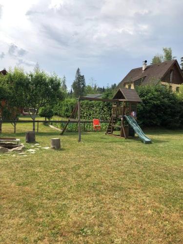 a park with a playground with a slide and a slideintend at chata ORAVSKA priehrada in Námestovo