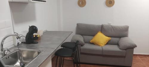 a living room with a couch and a sink and a kitchen at Loft 2 Nuevo ,segundo piso sin ascensor in La Línea de la Concepción