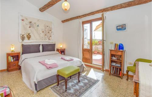 um quarto com uma cama, uma cadeira e uma janela em 2 Bedroom Nice Home In Farnese em Farnese