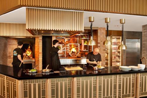 a group of people in a kitchen preparing food at JW Marriott Jeju Resort & Spa in Seogwipo