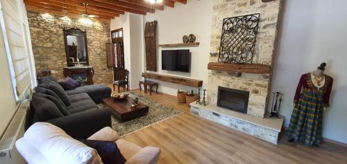 a living room with a couch and a fireplace at Bougainvillea House Lefkara in Pano Lefkara