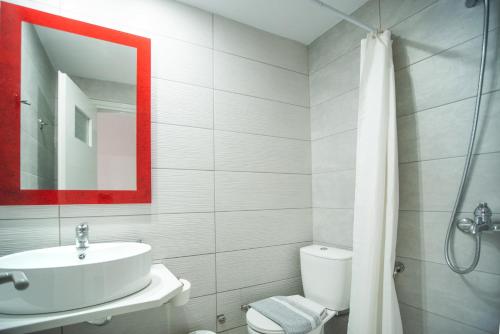 a bathroom with a sink and a toilet and a mirror at Christof Studios in Agia Galini