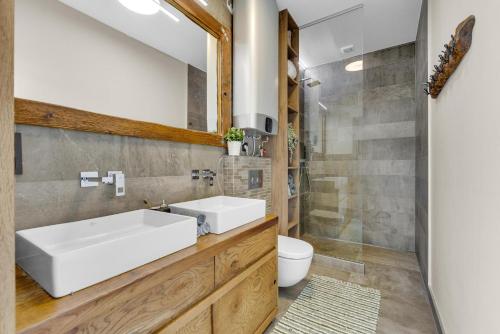 a bathroom with a white sink and a toilet at THE ROOT your charming floating home in Bratislava