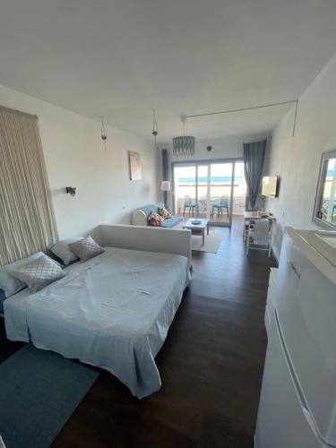 a bedroom with a bed and a living room at Azul apartment with sea view in Morro del Jable