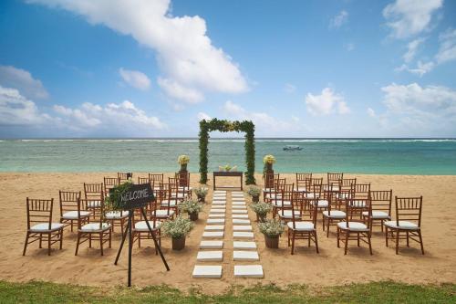 a wedding ceremony on the beach with chairs and an altar at The Westin Resort Nusa Dua, Bali in Nusa Dua