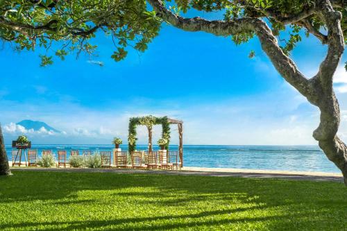 a wedding ceremony on the beach with the ocean in the background at The Westin Resort Nusa Dua, Bali in Nusa Dua
