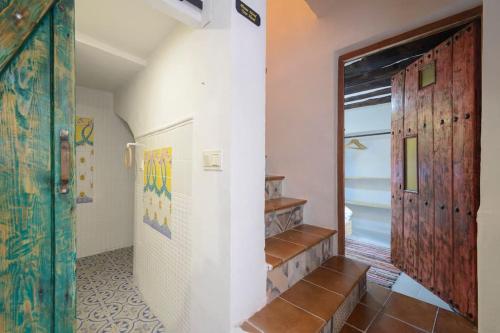 a hallway with stairs and a door in a room at The Tile House in Güéjar-Sierra