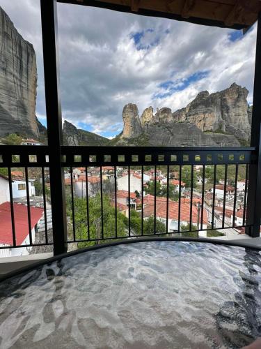 a room with a view of the mountains from a balcony at Meteora Sunrise in Kalabaka
