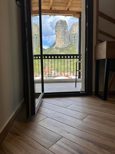 an open door with a view of a rock formation at Meteora Sunrise in Kalabaka