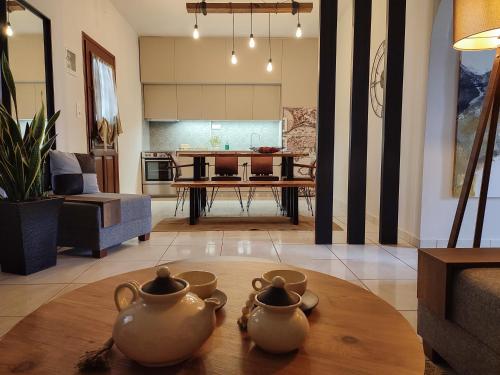 a living room with two tea pots on a table at Niki`s Luxury Apartment in Makry Gialos