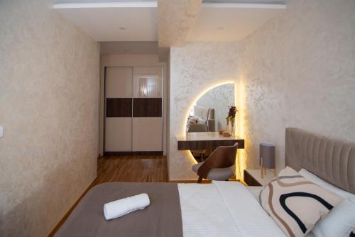 a hotel room with a bed and a desk at Hemingway LUX in Arandjelovac