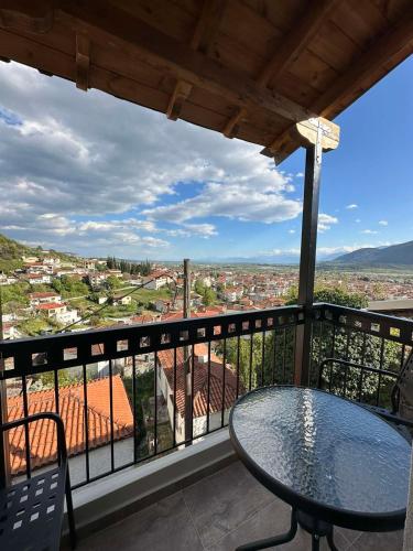 a balcony with a table and a view of a city at Meteora Sunrise in Kalabaka