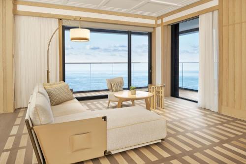 a living room with a couch and a table at JW Marriott Jeju Resort & Spa in Seogwipo