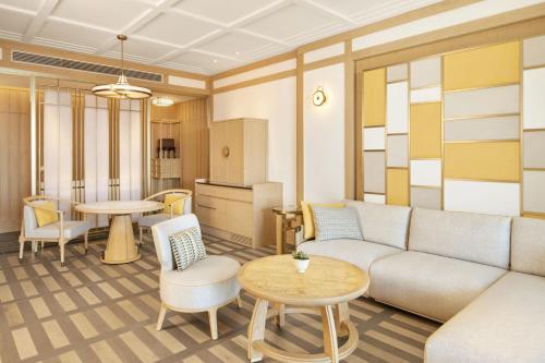a living room with a couch and a table at JW Marriott Jeju Resort & Spa in Seogwipo