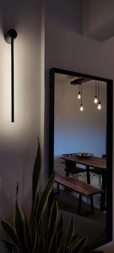 a room with a ping pong table and a mirror at Niki`s Luxury Apartment in Makry Gialos