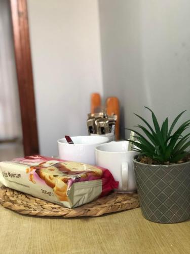 a tray with a sandwich and bowls on a table at The 3 Little Pigs apartments in Sidari