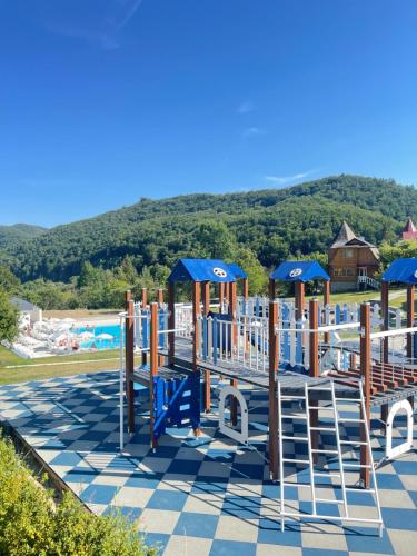 a playground at a resort with mountains in the background at BAYKA - SPA resort in Kosiv