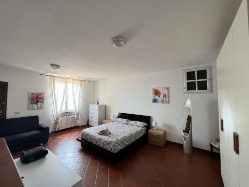 a bedroom with a bed and a living room at Casa Sancio in Spotorno